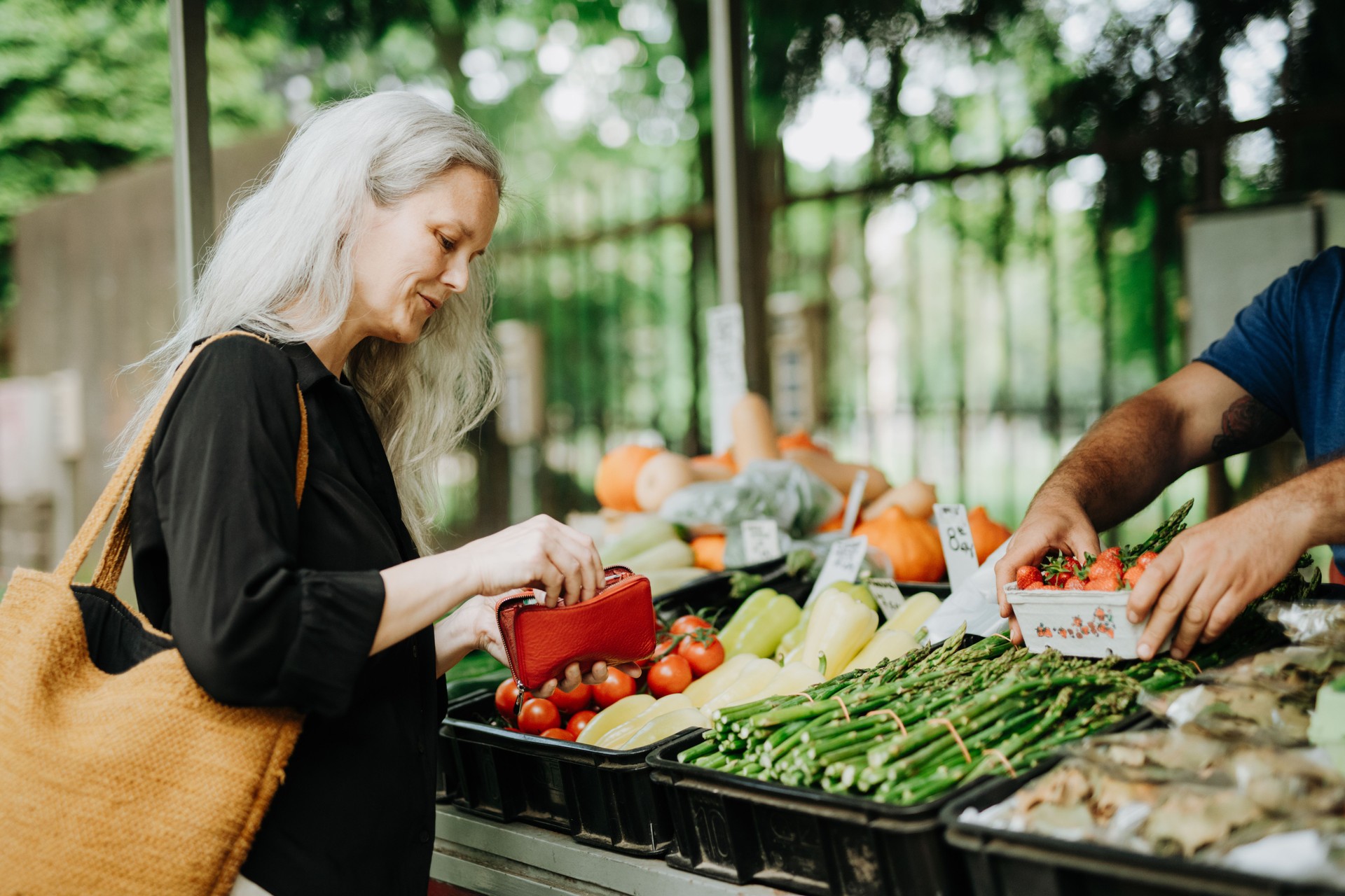 Portrait of a beautiful mature woman shopping at market in the city.